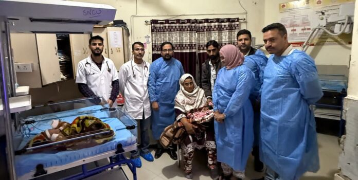 Healthcare professionals with newborn in GMC DodaNICU